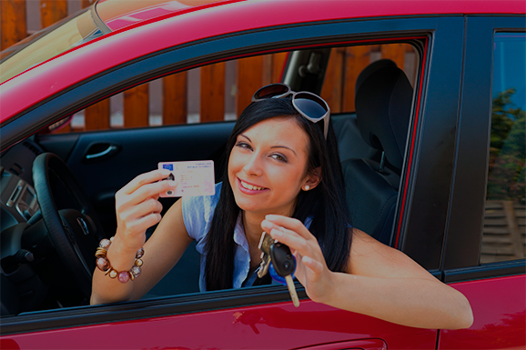 Young Female Driver Holding Hey Car Keys and Drivers License